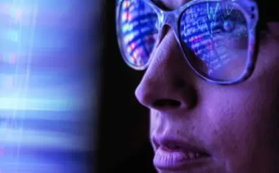 The face of a woman in glasses